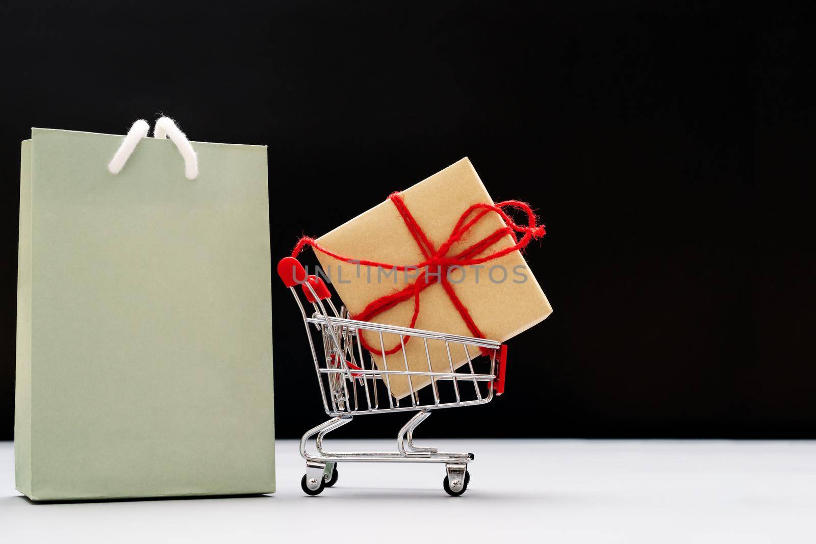 Boxing day sale, shopping cart, bag and gift box with copy space