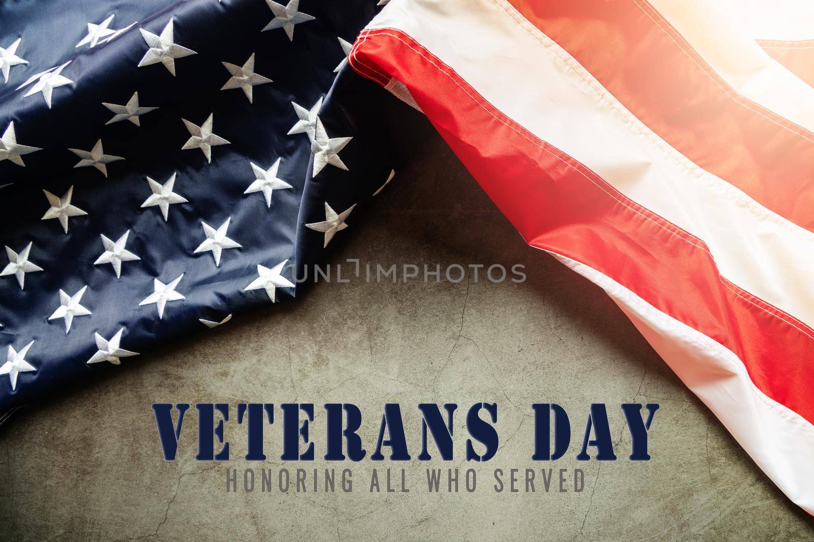 Veterans day. Honoring all who served. American flag on cement background by psodaz