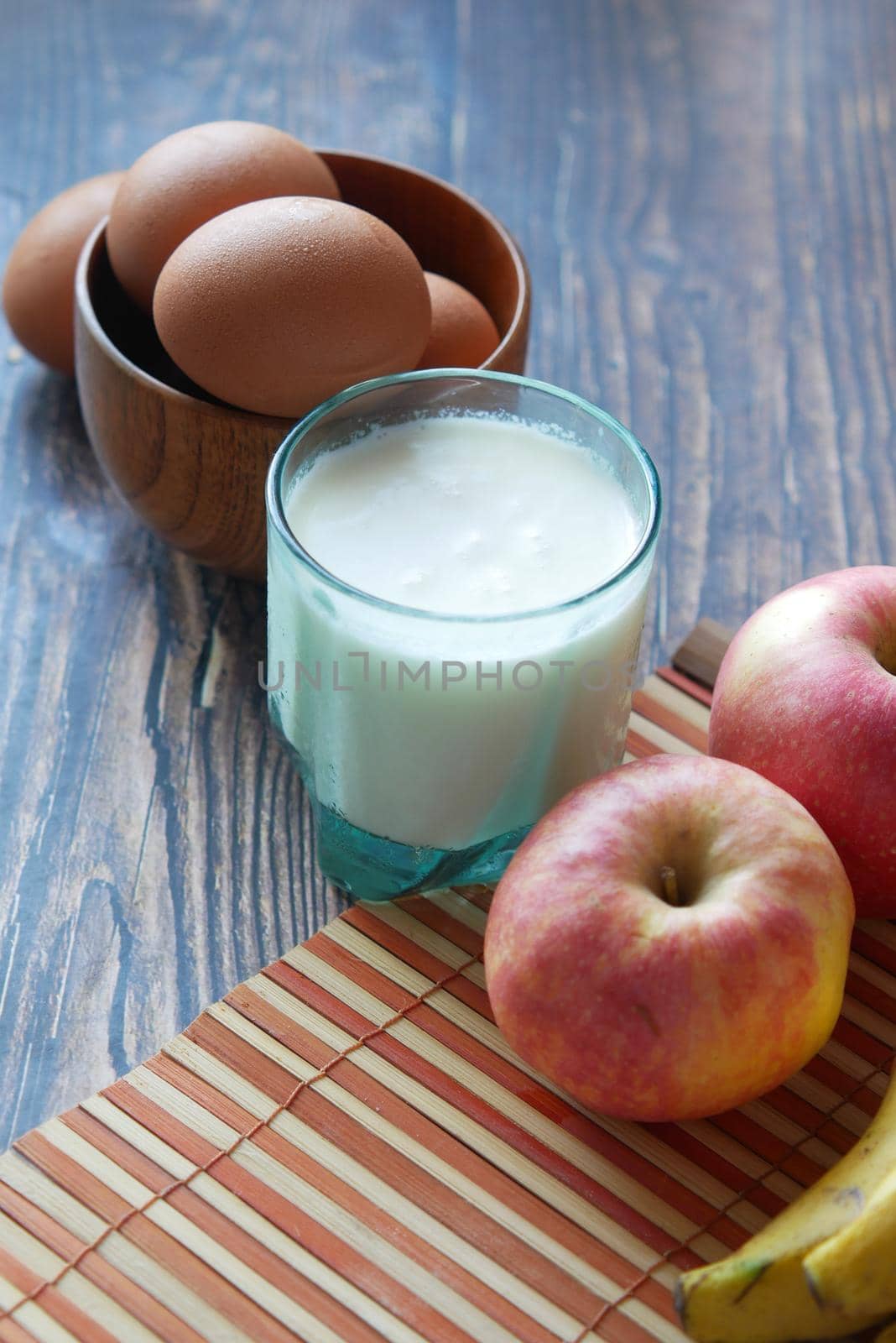 healthy snack concept with milk and apple on table