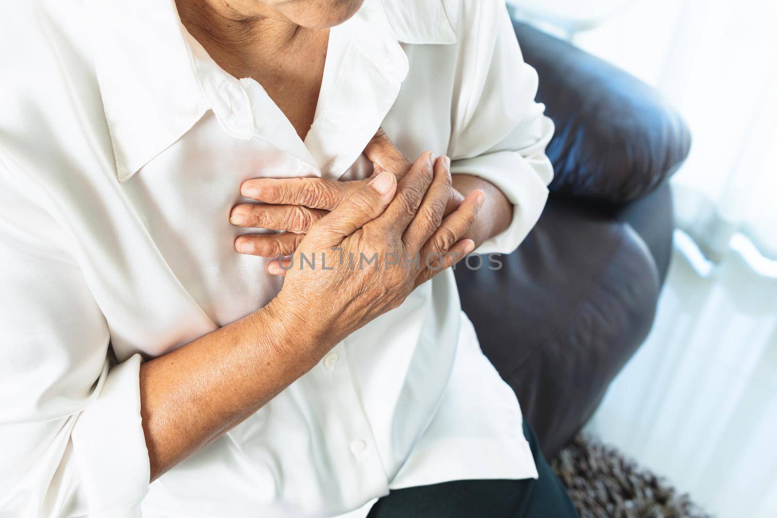 old woman having heart attack and grabbing her chest by psodaz
