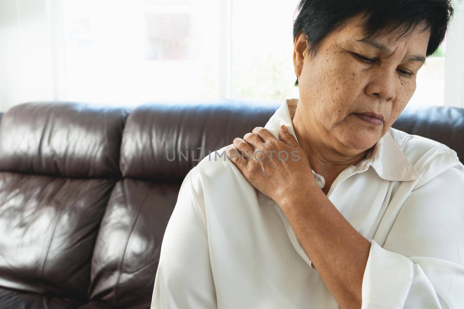 neck and shoulder pain, old woman suffering from neck and shoulder injury, health problem concept