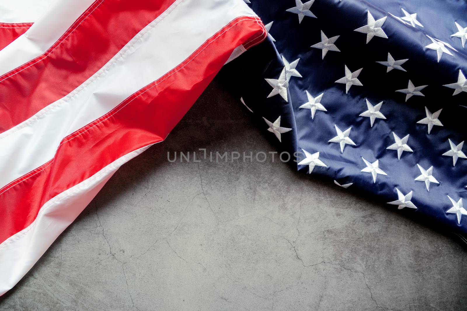 Veterans day. Honoring all who served. American flag on gray background with copy space. by psodaz