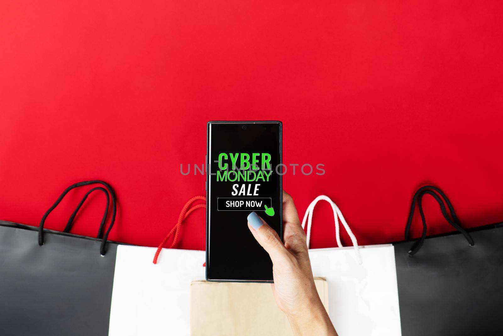 Cyber Monday Sale Clearance Discount Concept, woman hand holding smartphone with shopping bag. by psodaz