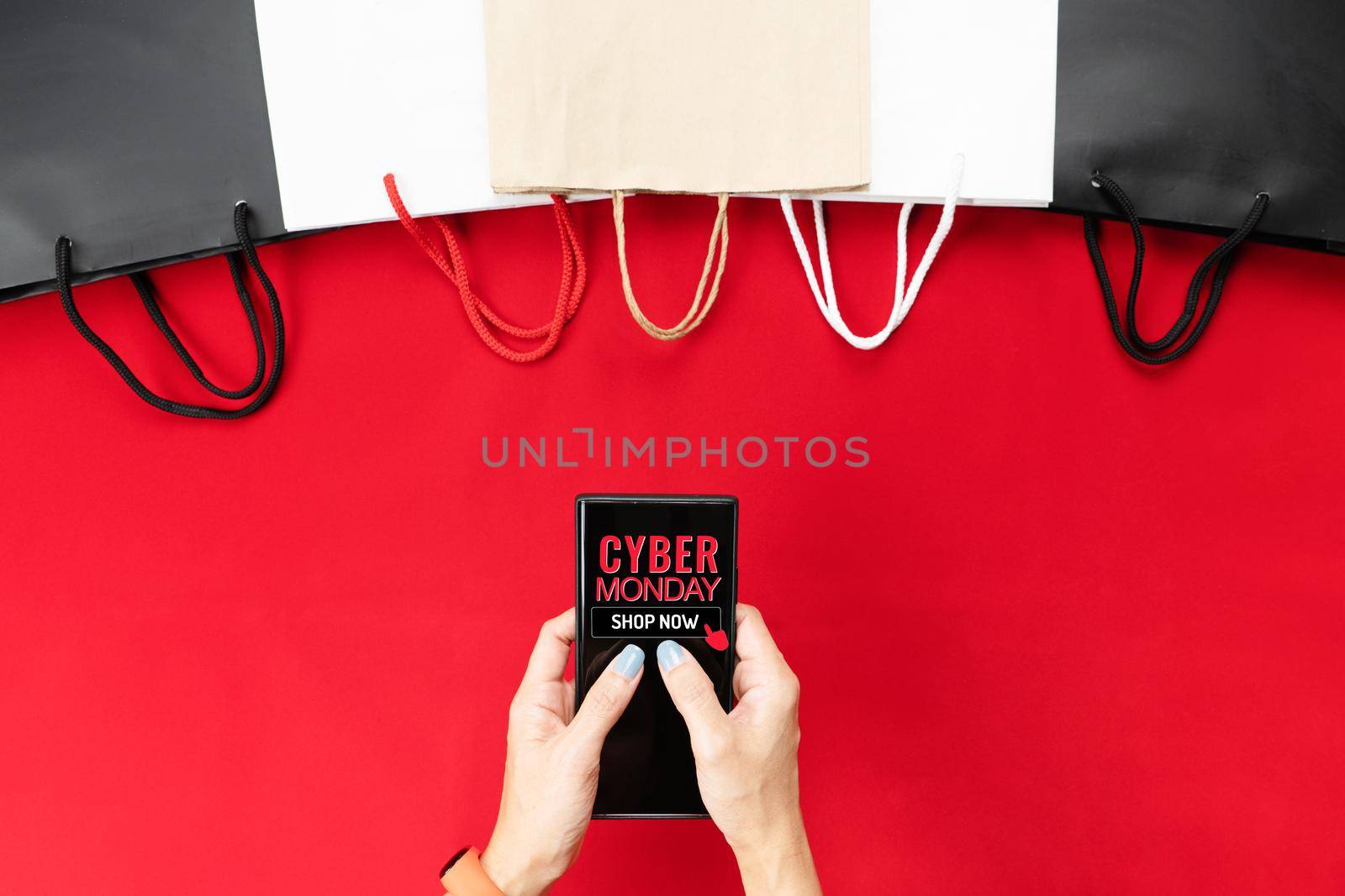 Cyber Monday Sale Clearance Discount Concept, woman hand holding smartphone with shopping bag.
