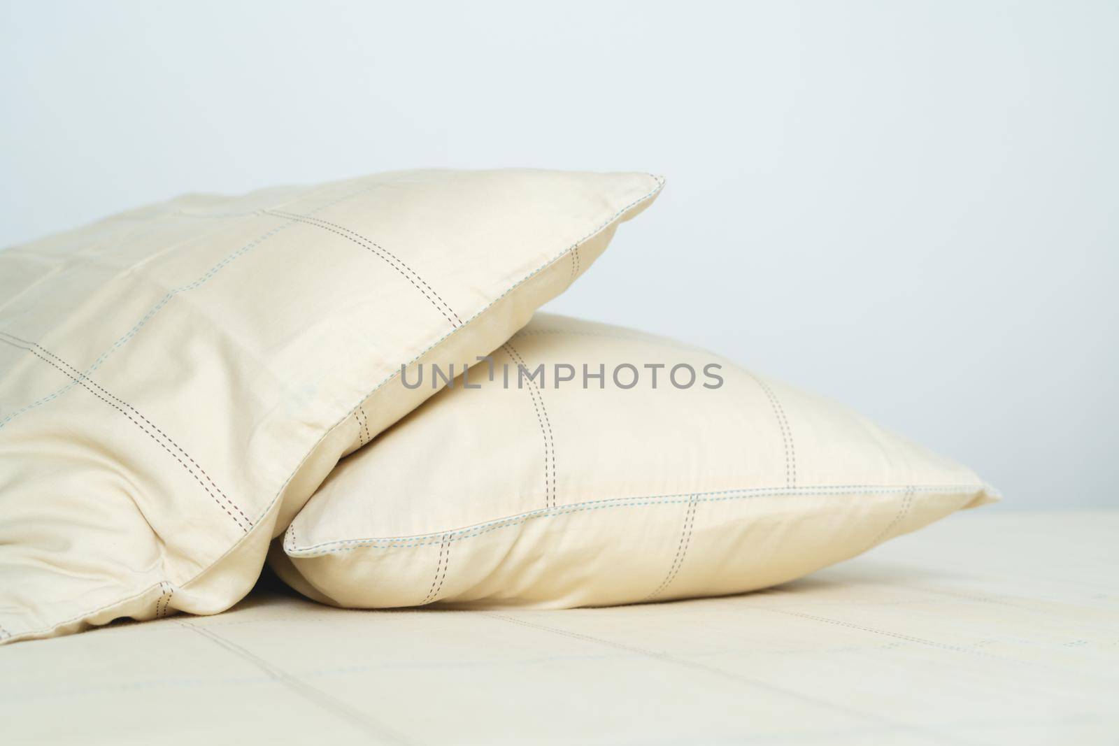 couple comfortable soft yellow pillows on bed by psodaz