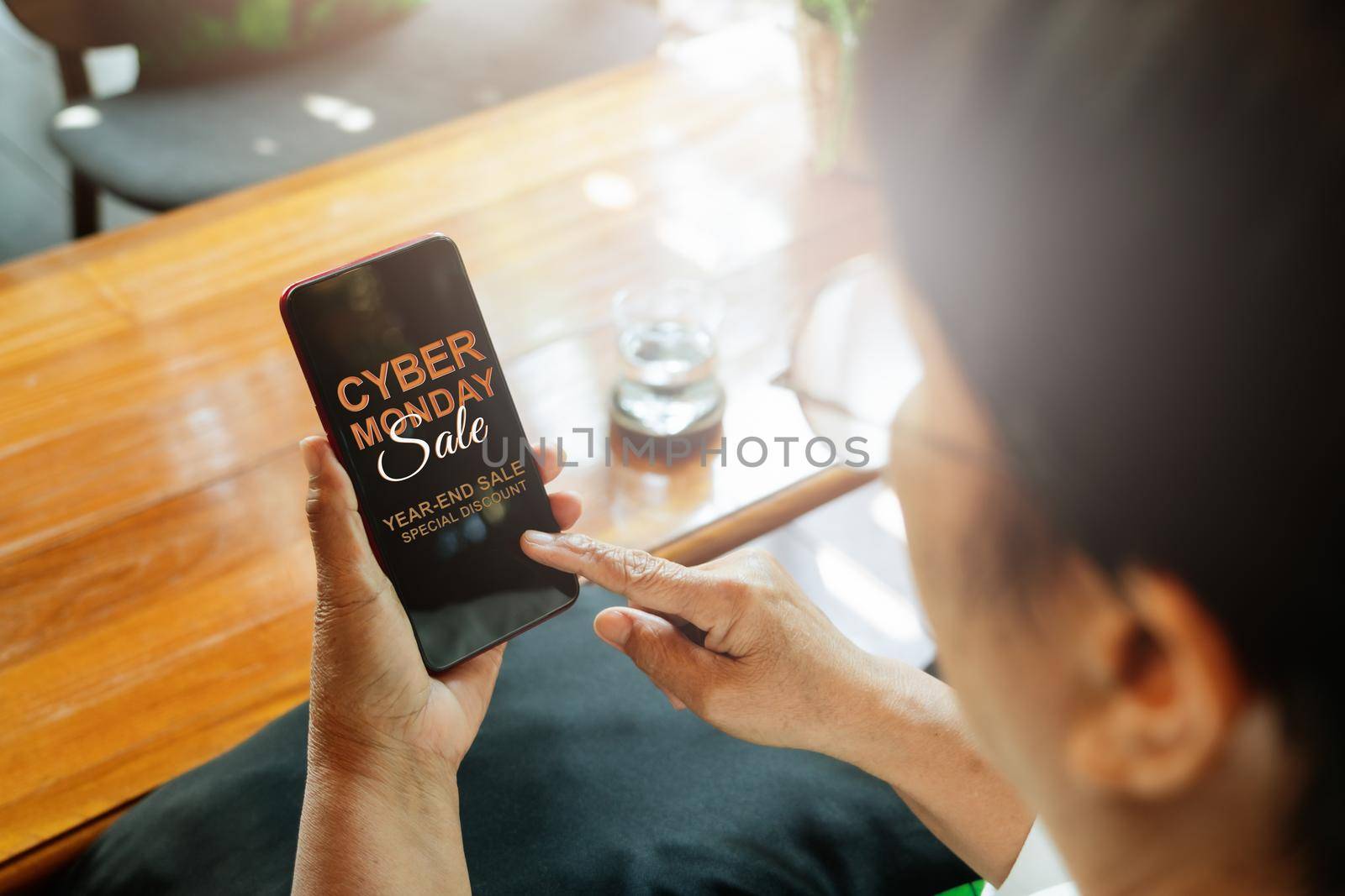 Cyber Monday Sale Concept, Senior woman hand holding smartphone for online shopping by psodaz