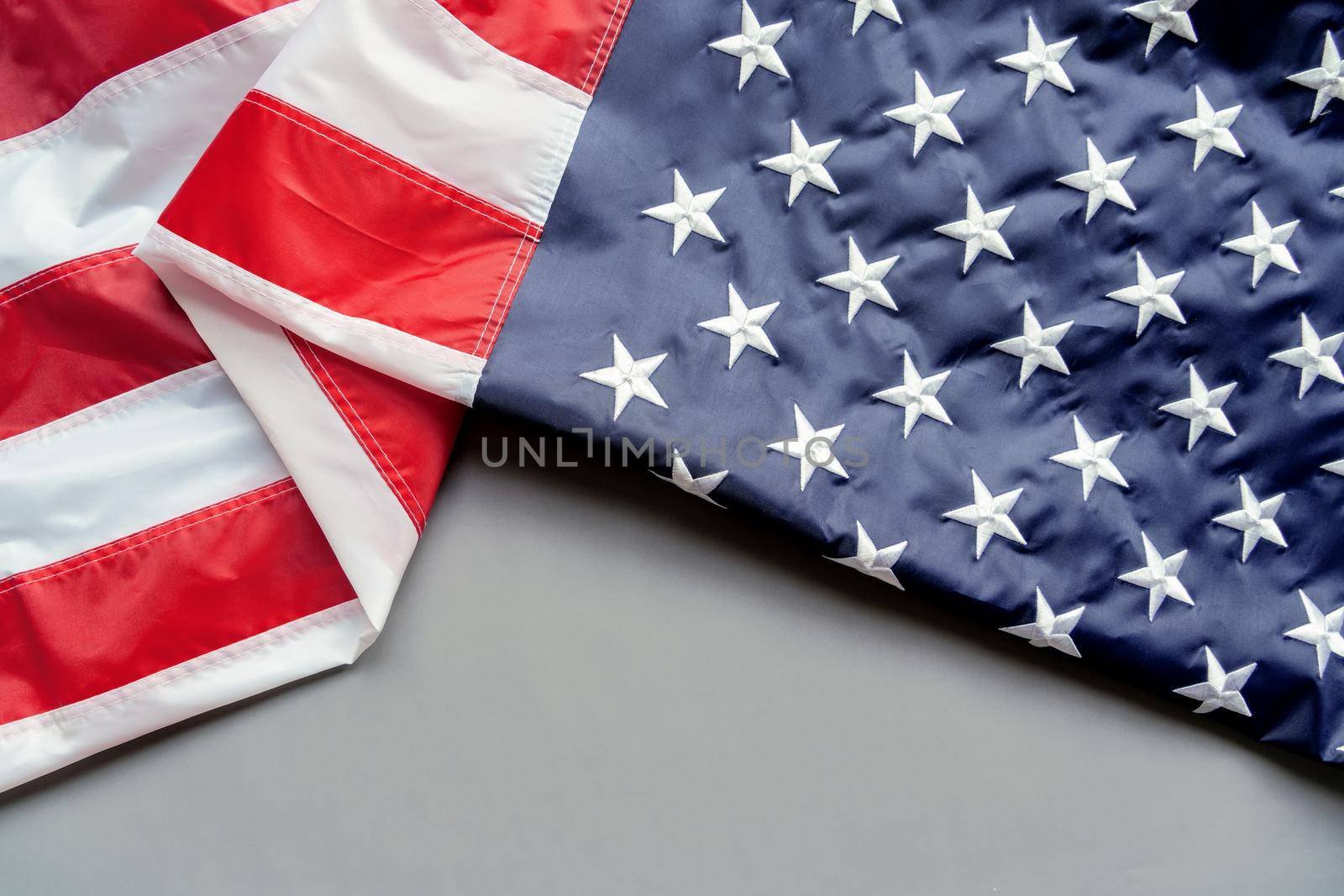 Veterans day. Honoring all who served. American flag on gray background with copy space.