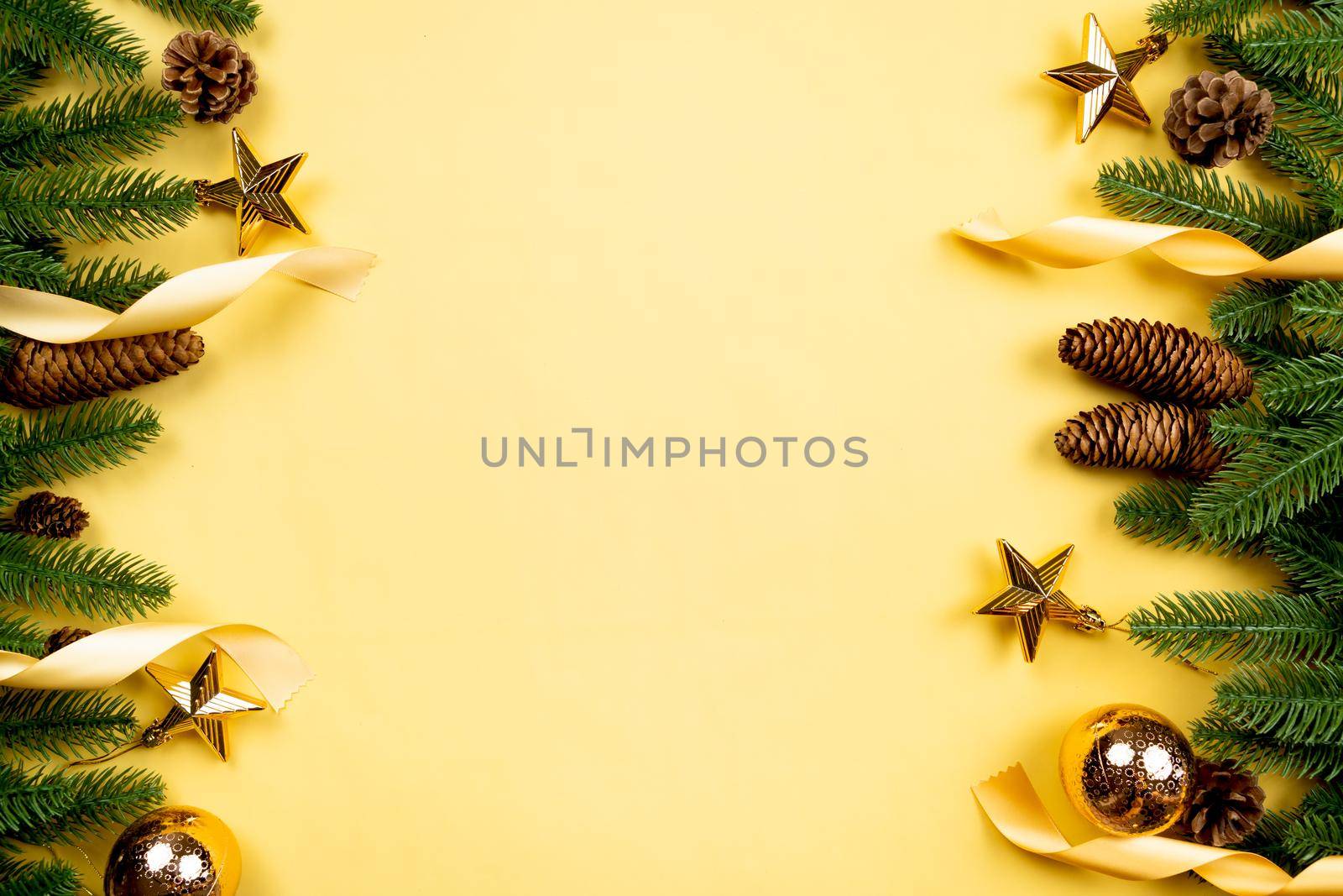 Christmas background, pine tree with xmas decoration on yellow background