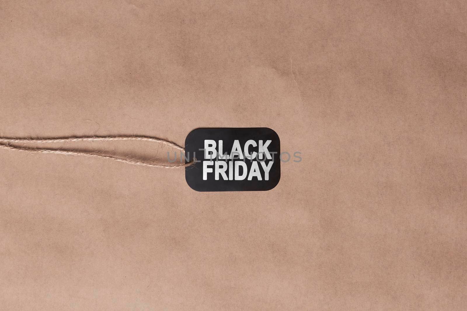 Black friday concept. Sale shopping tag on craft background