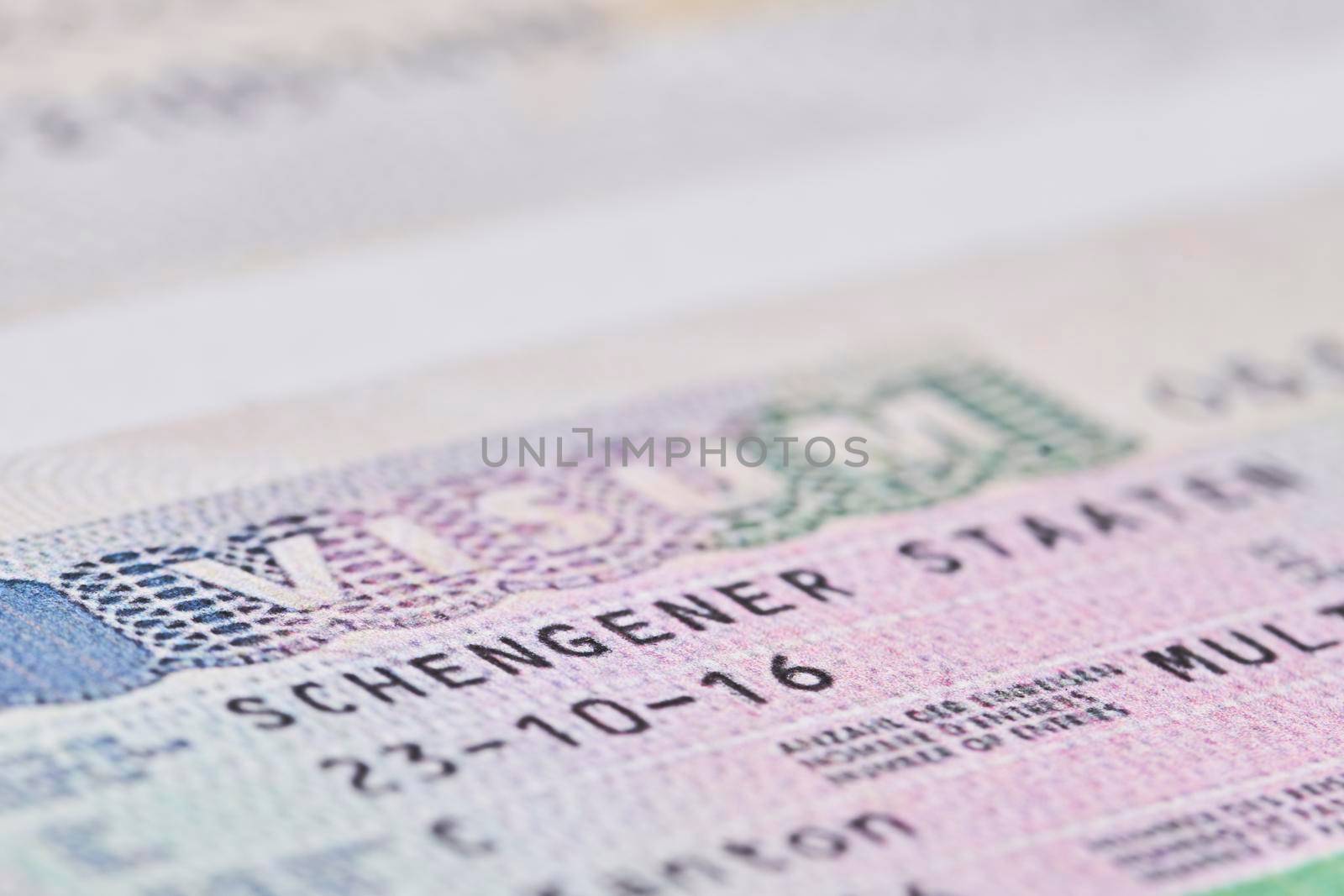 Schengen visa in passport. Close-up by golibtolibov