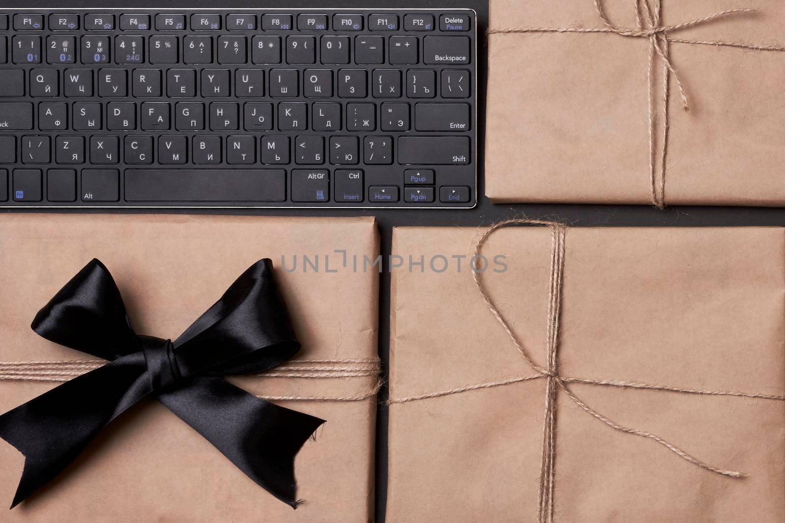 Black friday concept. Pile of giftboxes with computer keyboard
