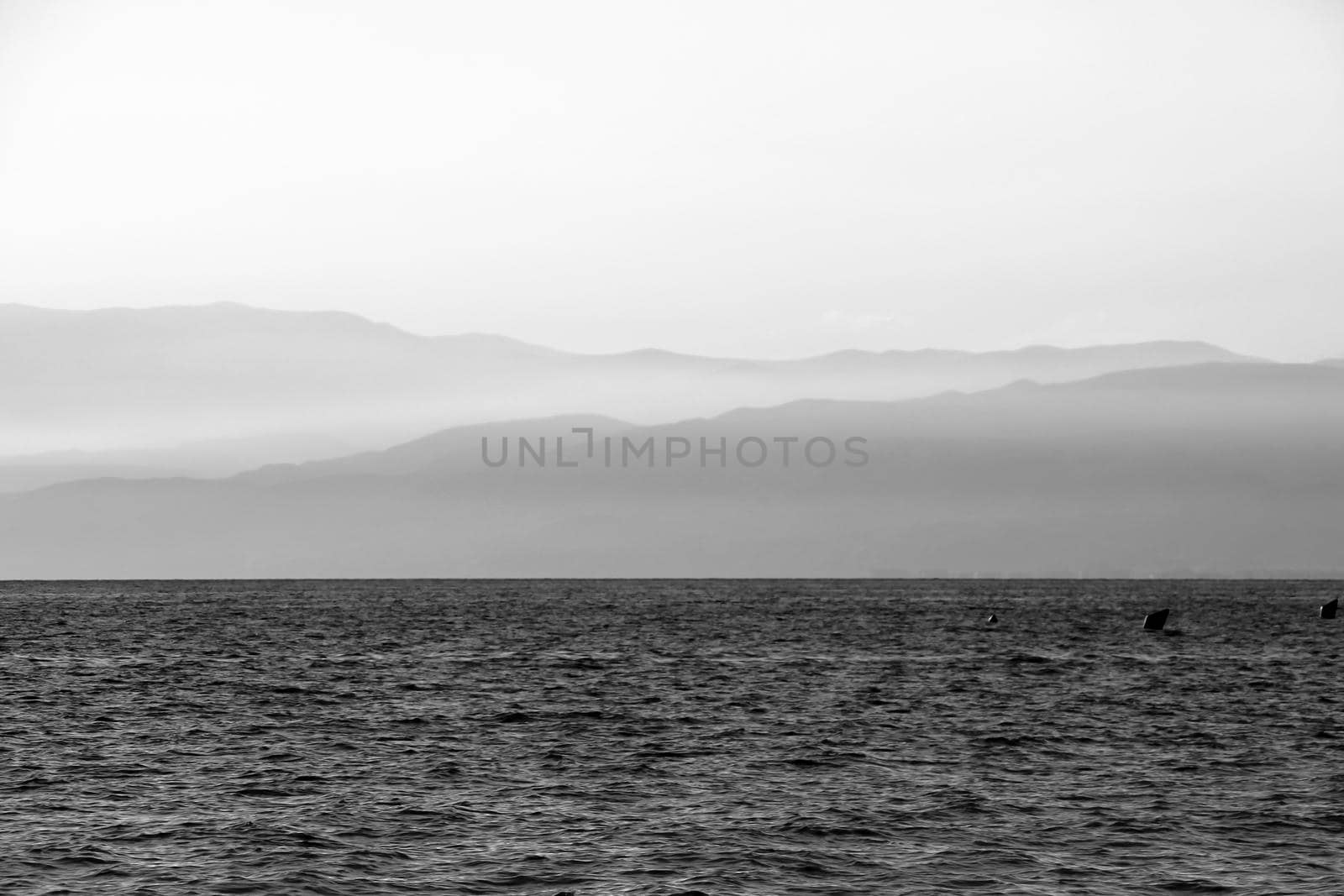 Afternoon on the Salinas beach in Cabo de Gata, Almeria, Spain. Foggy Mountains in the background. Monochrome picture.