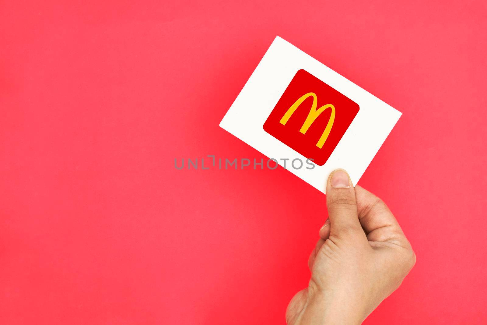Tashkent, Uzbekistan - April 2, 2021: Hand holds a card with McDonalds logo