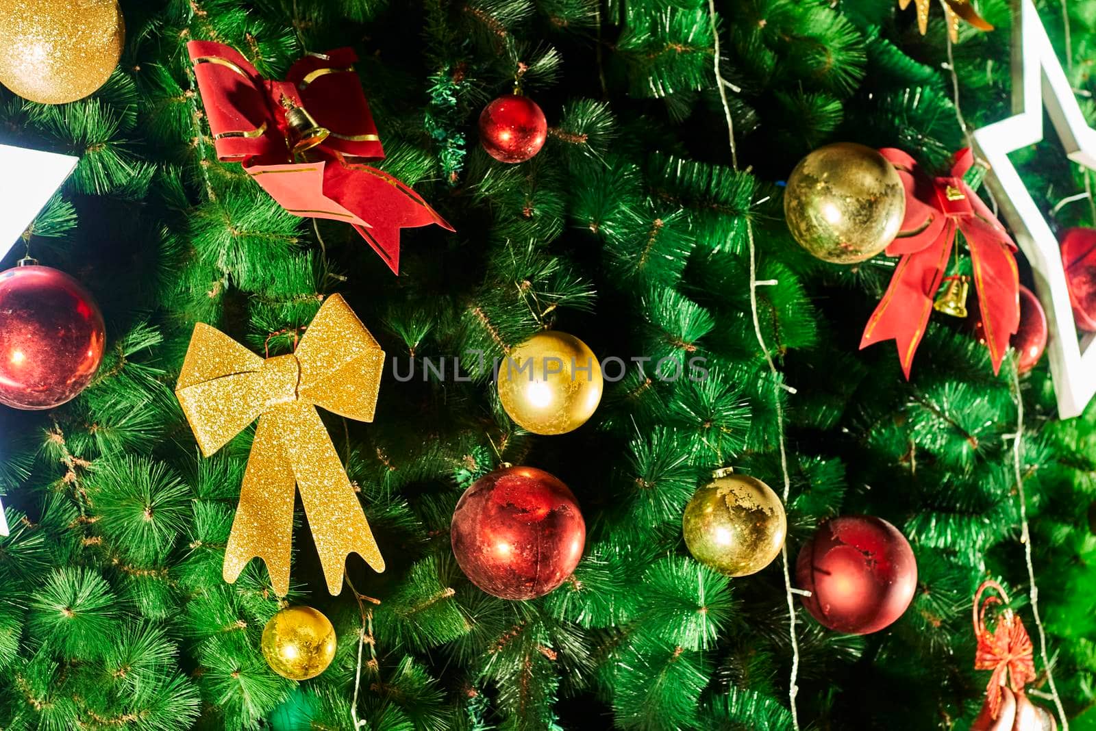 Festive Christmas tree background with decorations. Merry Christmas background. Closeup shot of Christmas tree with Xmas decorations
