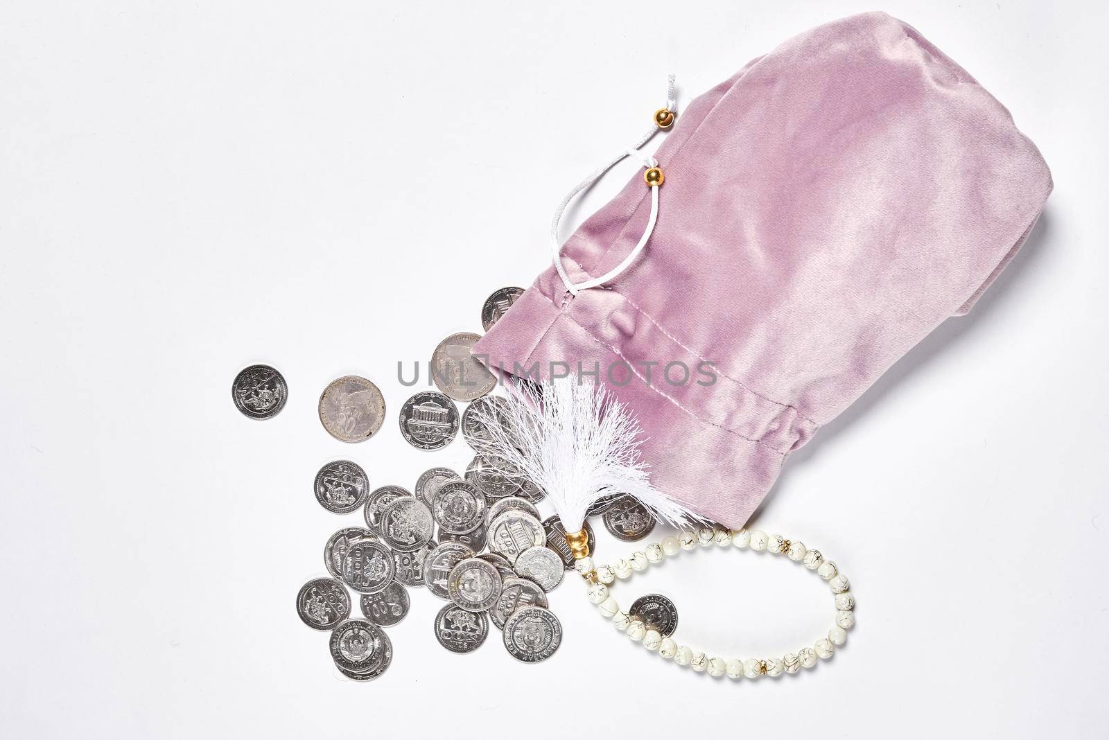 Concept of islamic finance on white background. Sharia-compliant finance - banking or financing activity. Coins and praying beads. Zakat, islamic banking