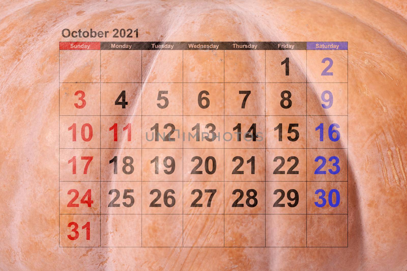 Close-up of pumpkin surface and October monthly calendar