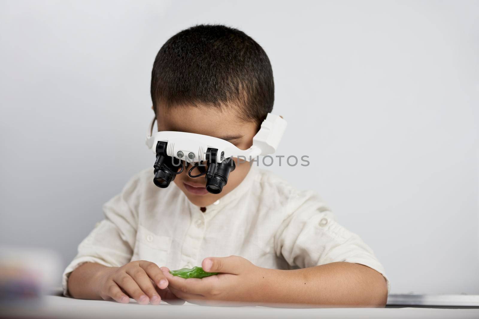 A smart boy with headband magnifying glass by golibtolibov