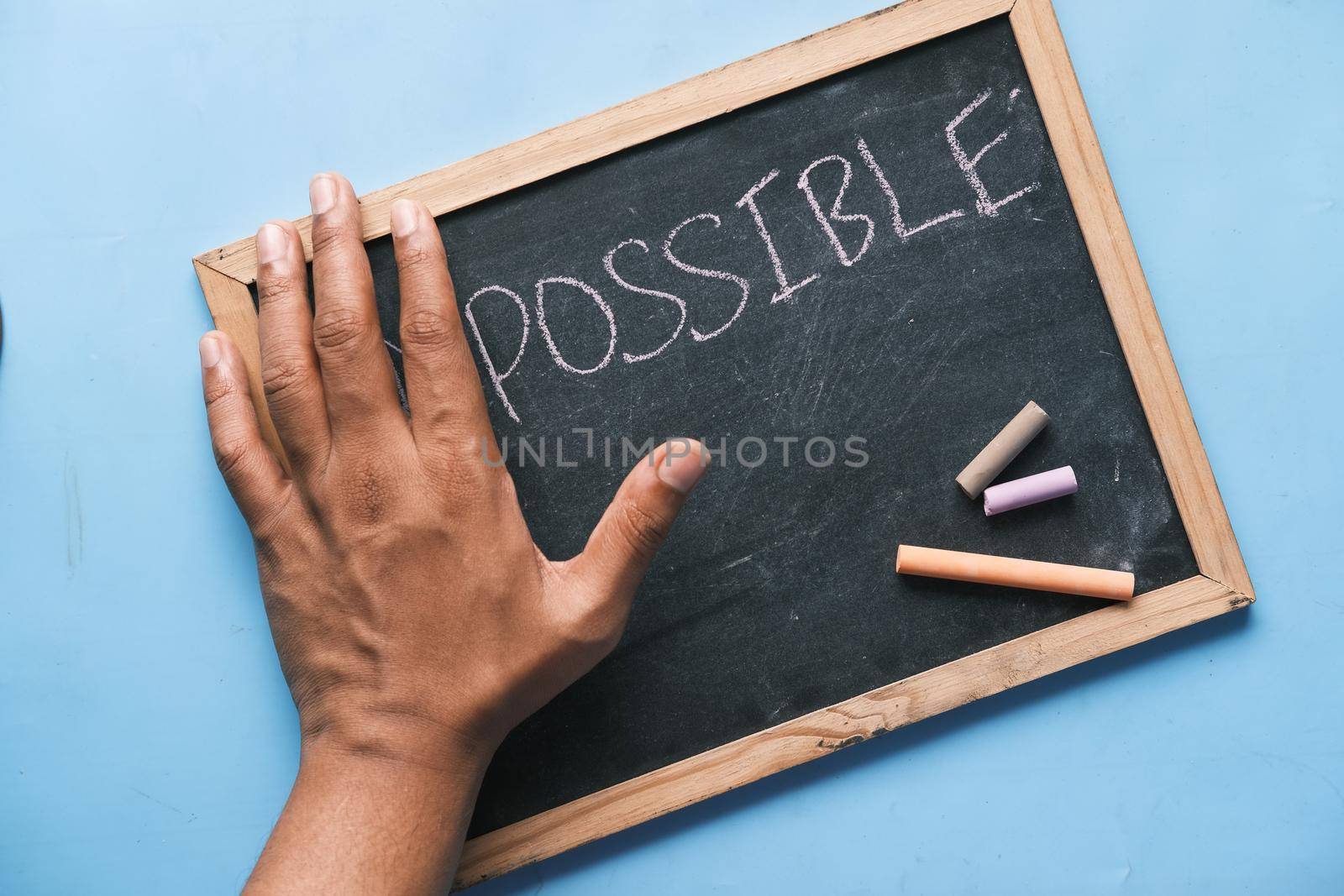 young man hand over impossible text