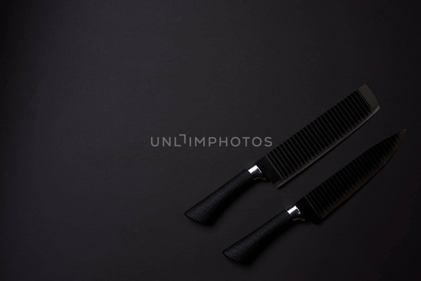 Black friday concept. Set of sharp kitchen knifes. Black knifes on dark background