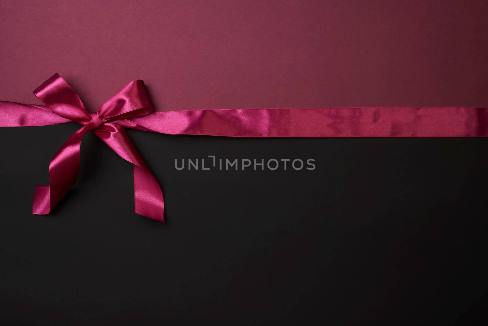 Creative Black Friday concept made with pink ribbon on dark background