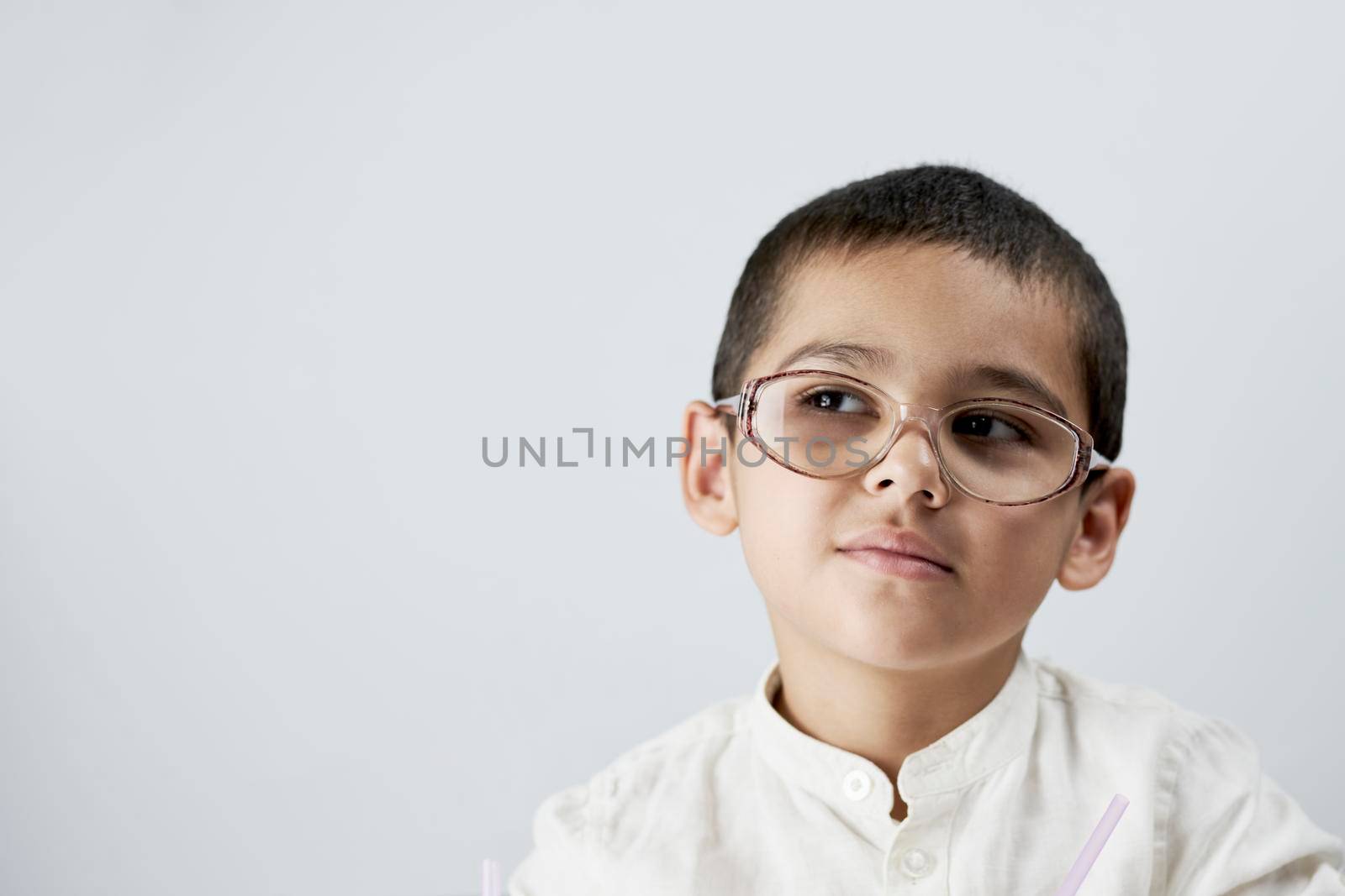 Smart boy in glasses against the white background
