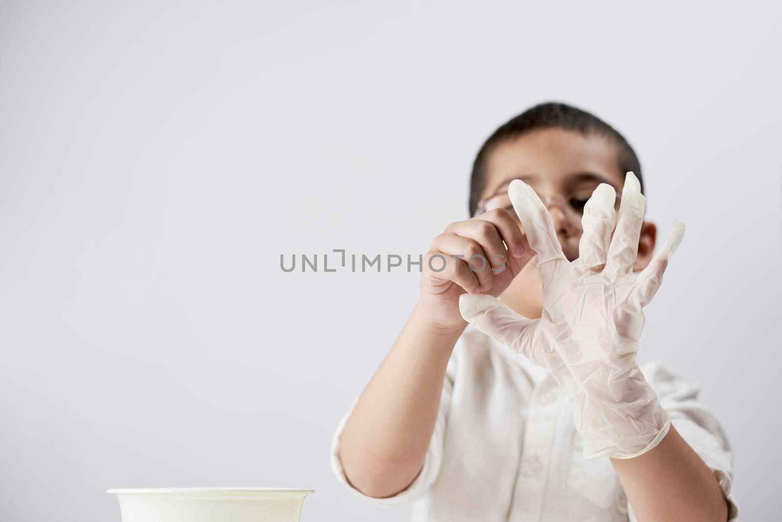 A boy wearing medical gloves by golibtolibov