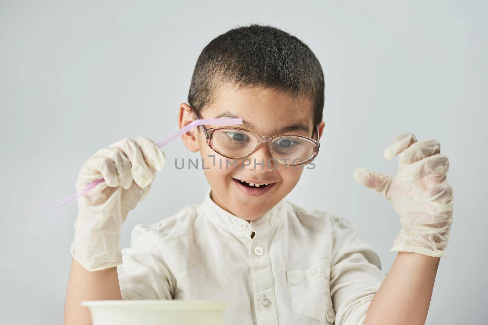 Funny kid making experiments at the workshop and exploring the world of chemistry by golibtolibov