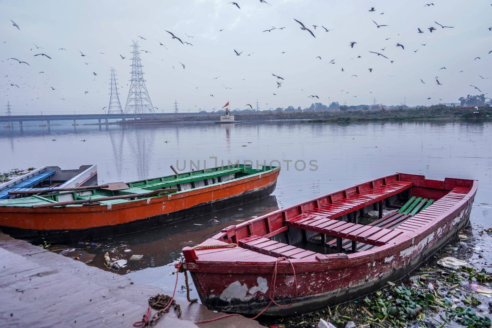 colorful boats being parked at the bank of Yamuna river near nigam bodh ghat.