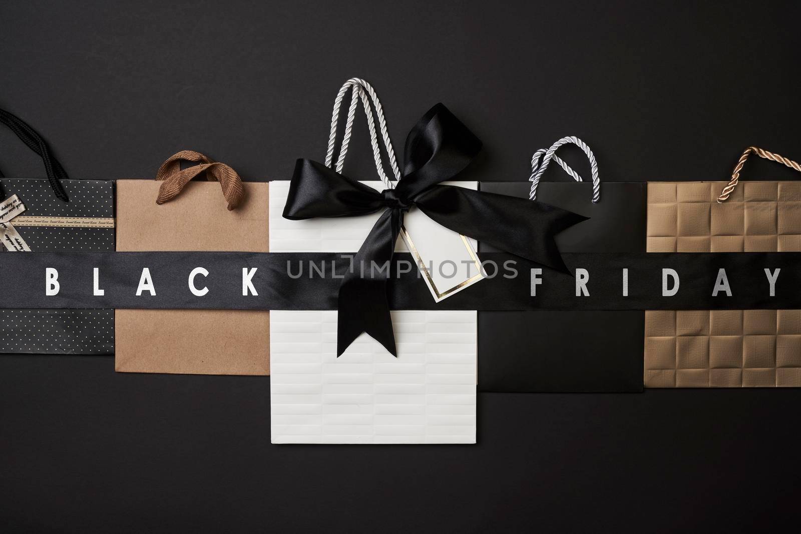 Black friday concept. Pile of various shopping bags on black background.
