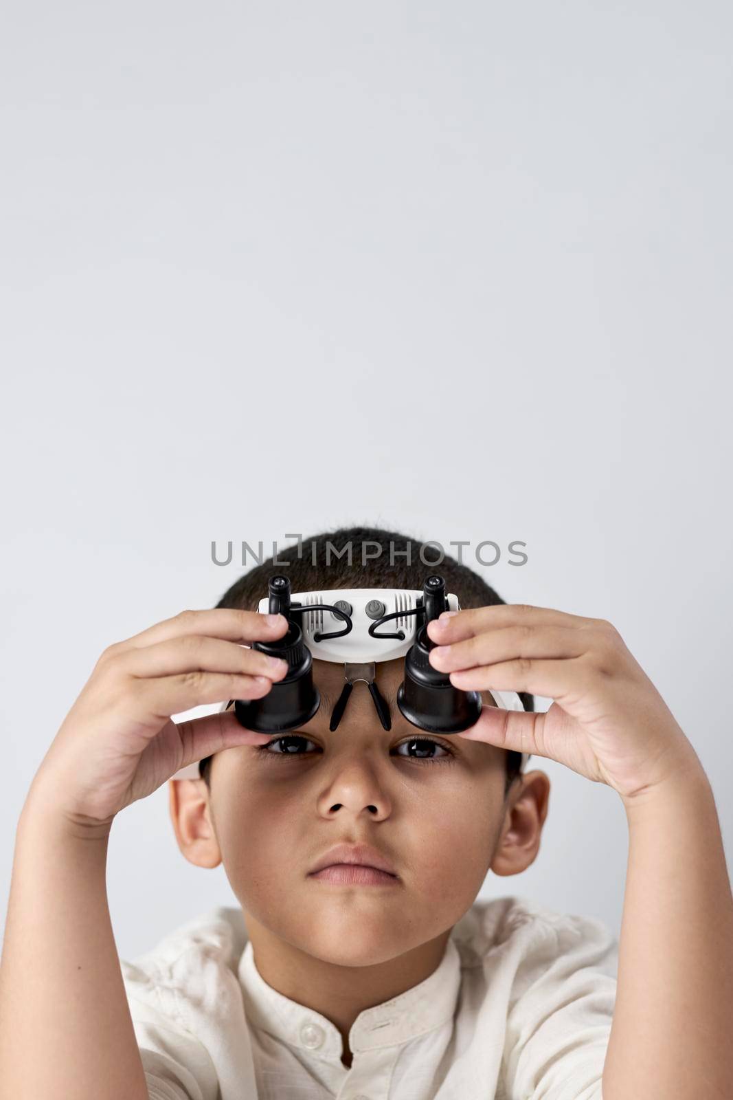 Boy in headband magnifying glass by golibtolibov