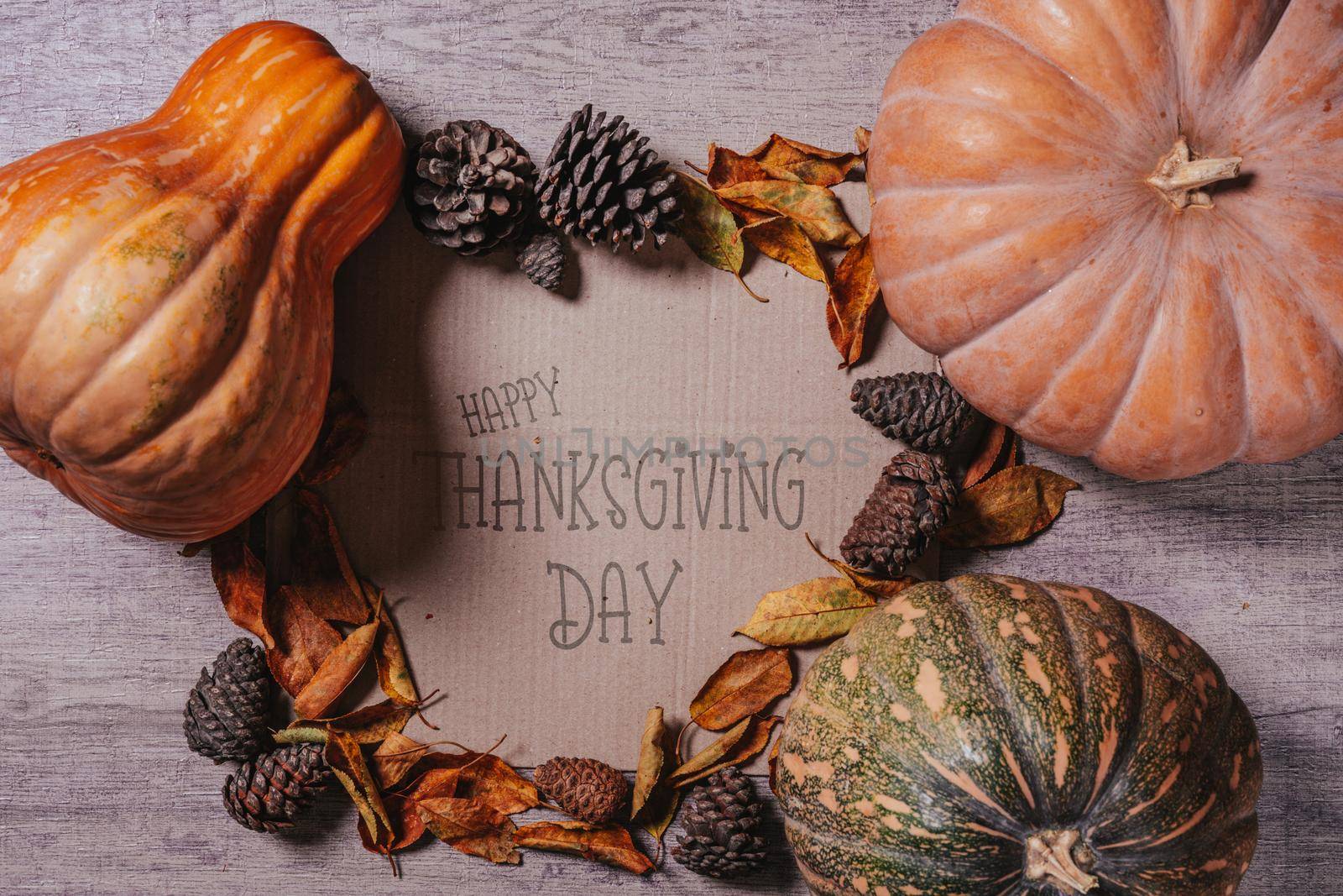 Happy thanksgiving day - Autumnal background with harvest fall vegetables and autumnal leaves on wooden background