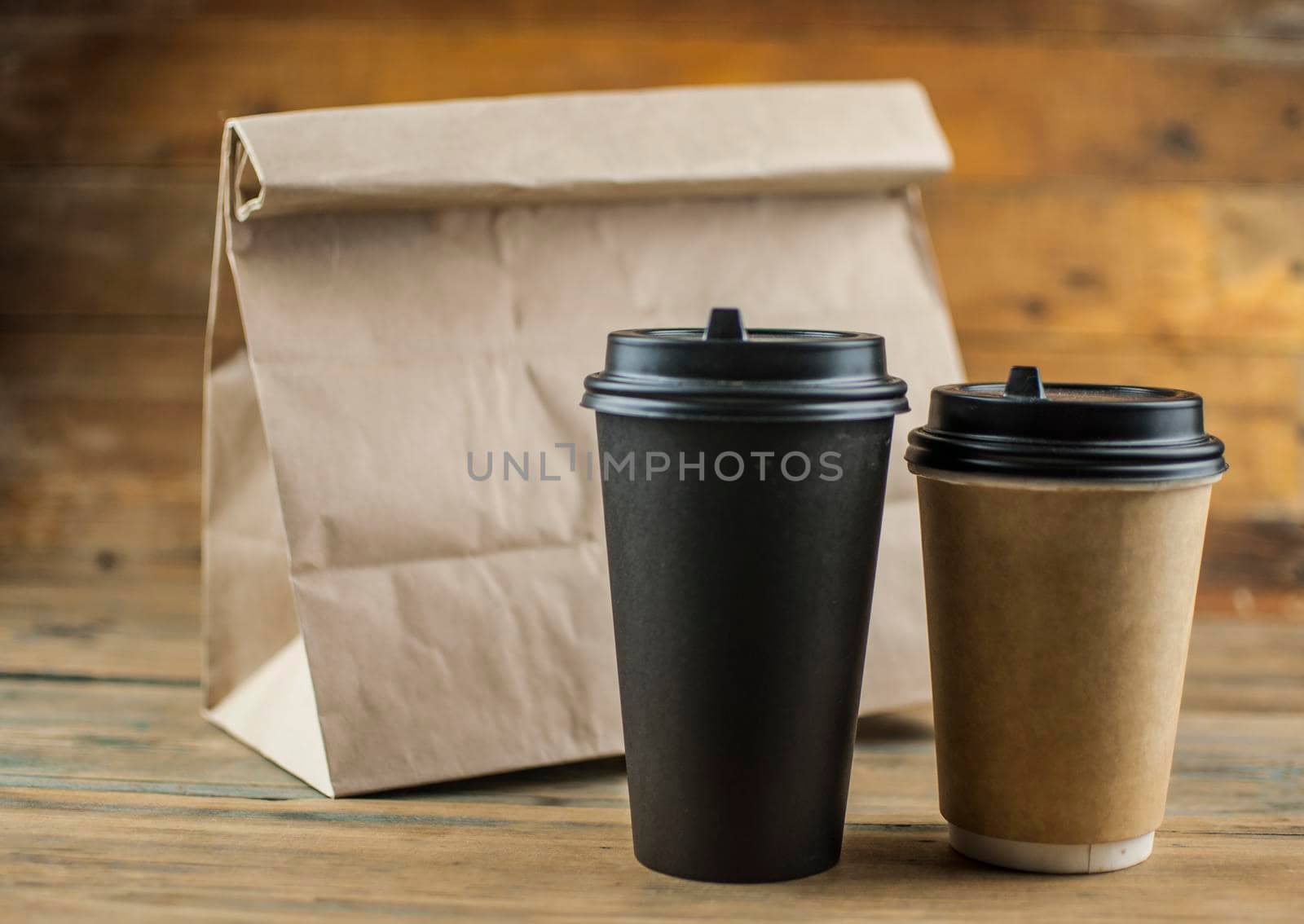Coffee in paper craft with bread bag wooden background by inxti