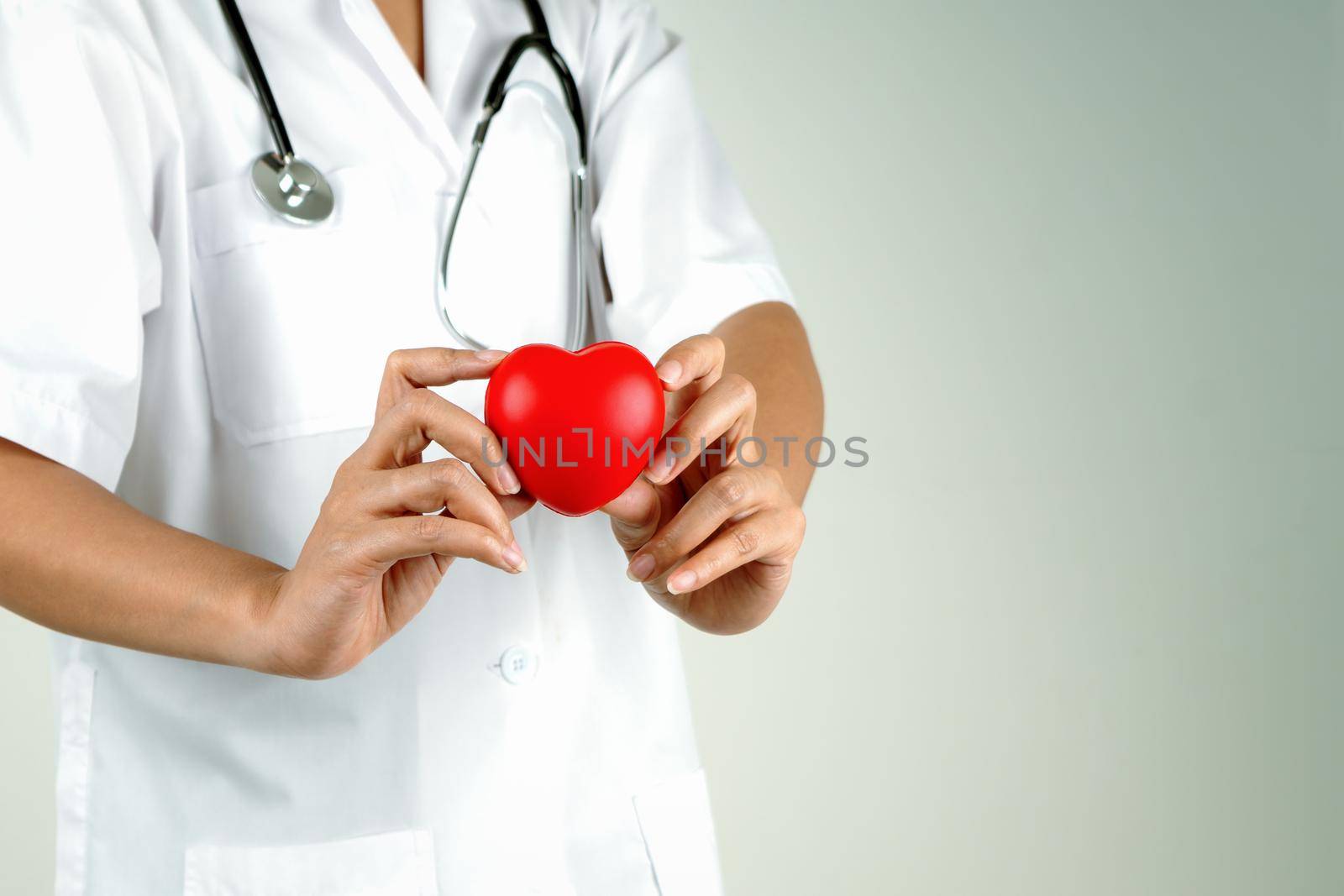 World heart day concept of woman doctor hand holding red heart