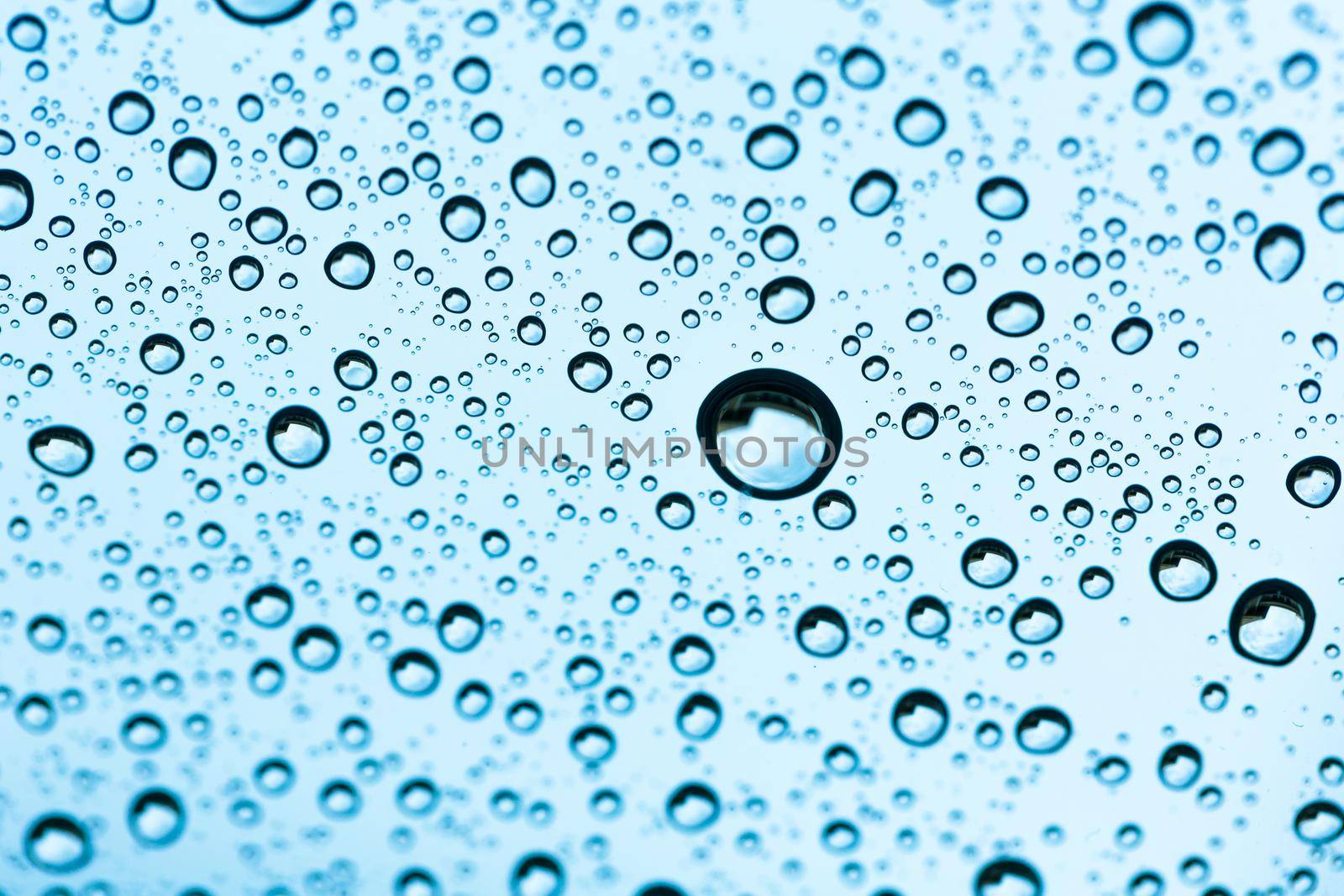 Water drop under water on background. by jayzynism