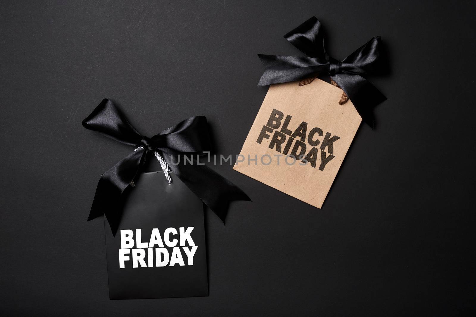 Black friday concept. Pile of various shopping bags on black background.