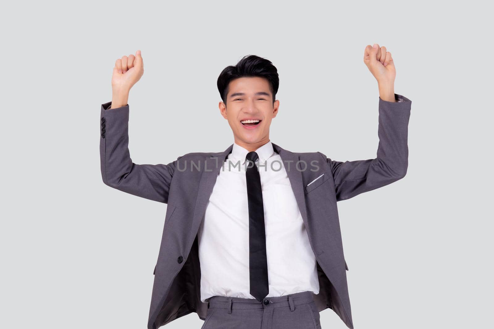 Portrait businessman in suit standing with win success isolated on white background, young asian business man is manager or executive having confident and excited is positive, expression and emotion. by nnudoo