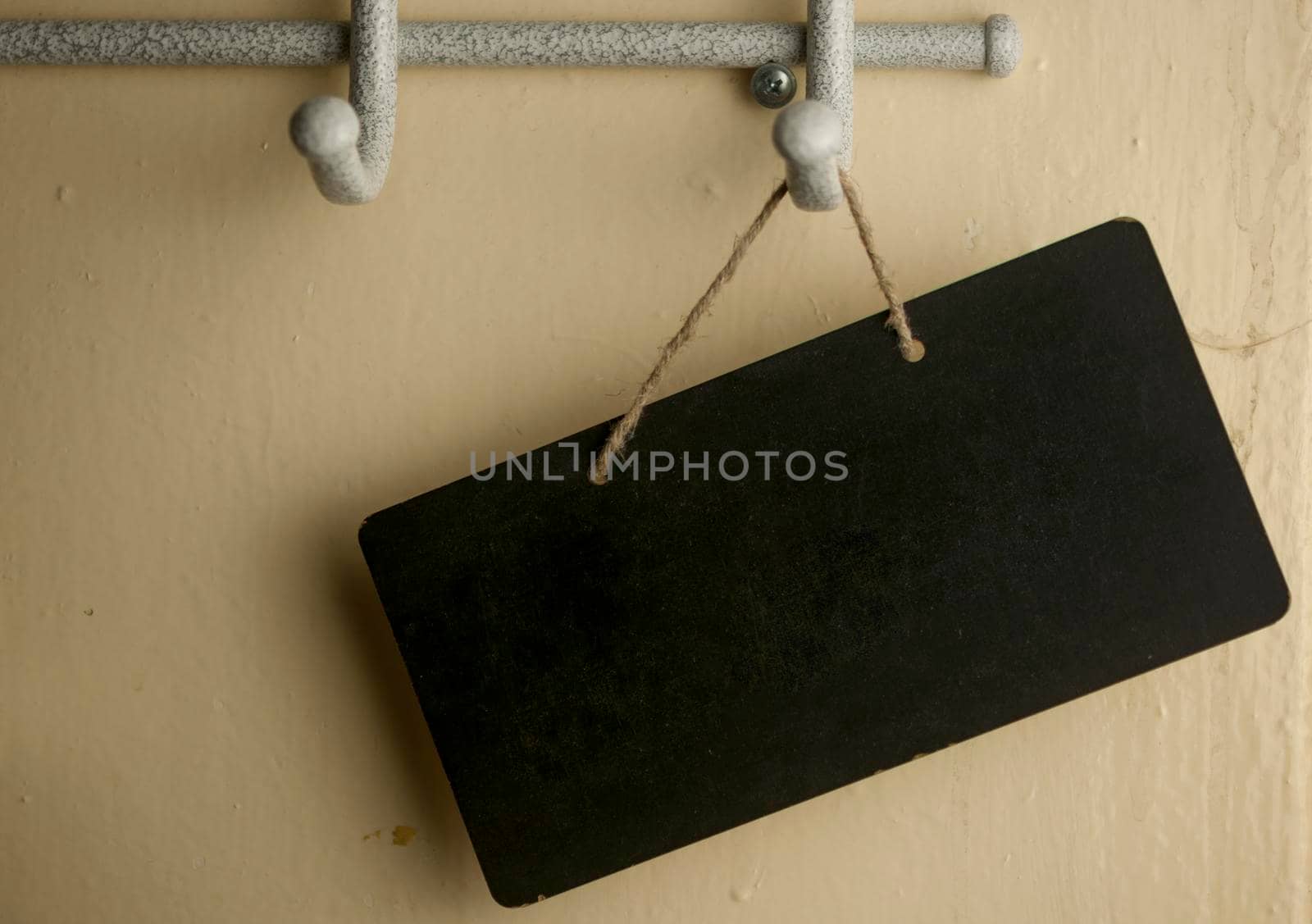 Black notice board with copy space over wooden background