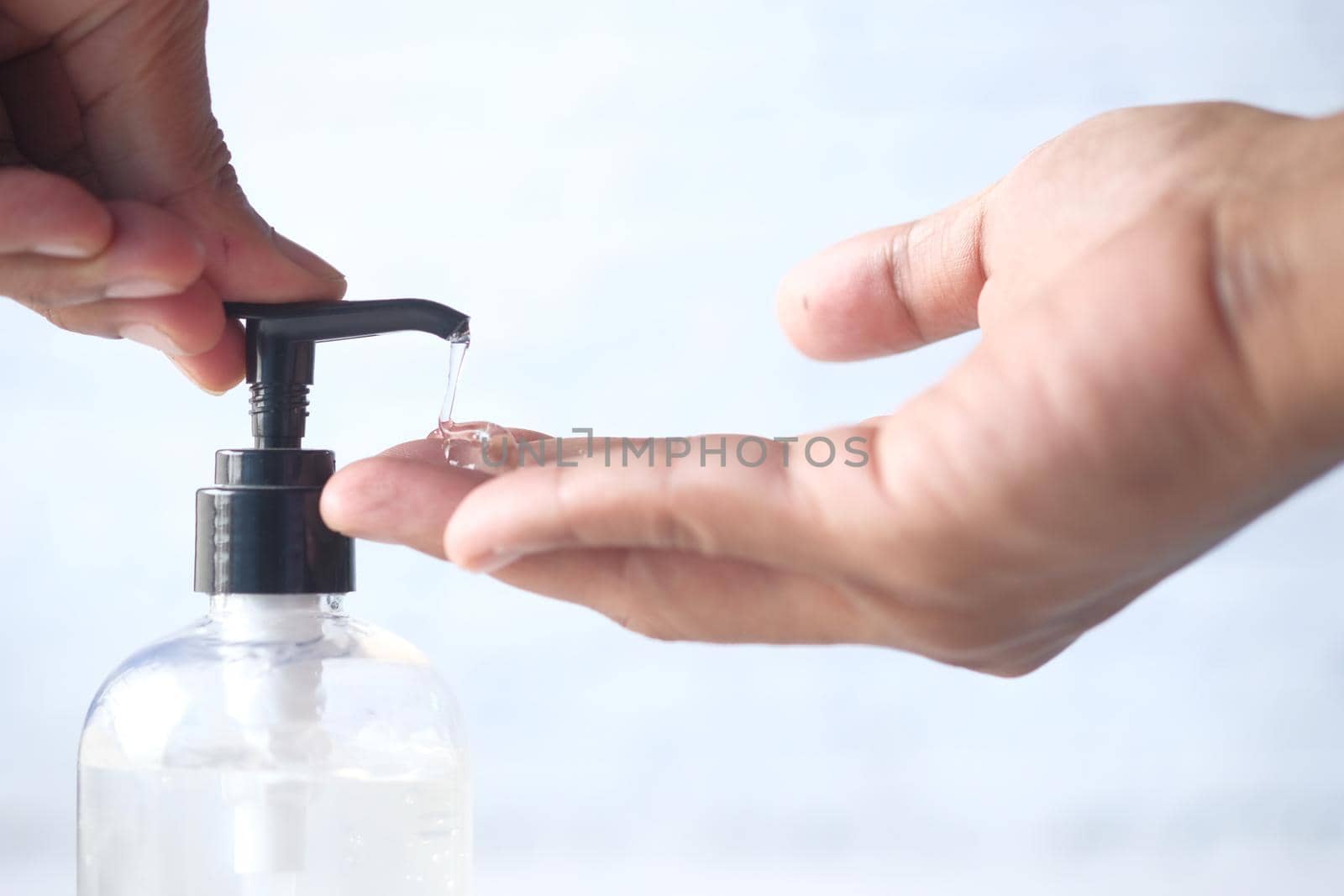 close up of young man hand using sanitizer gel for preventing virus.