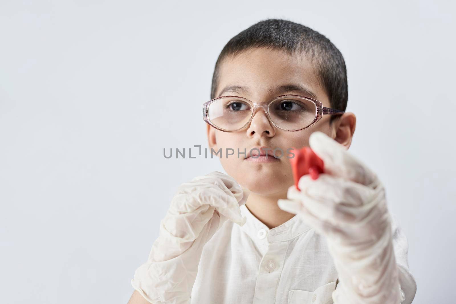 A boy in glasses plays with slime by golibtolibov