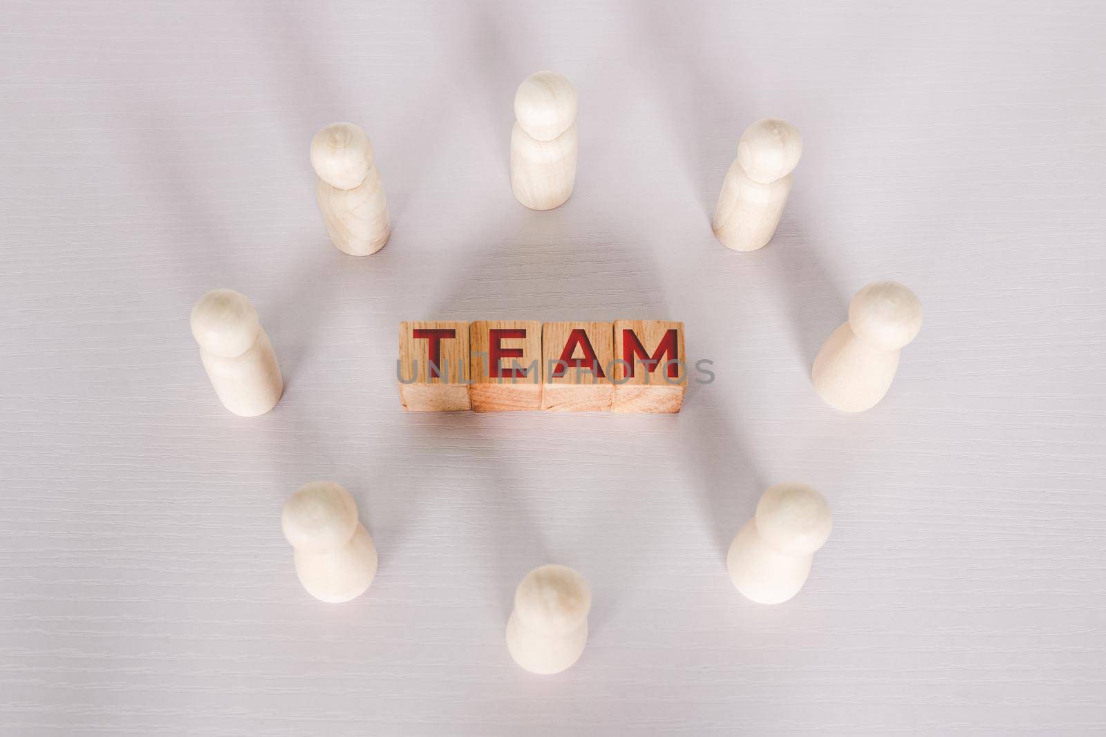 Word team on wooden block, relationship of collaboration and leadership for success, group of community and employee with corporate, teamwork for brainstorming together, no people, business concepts.