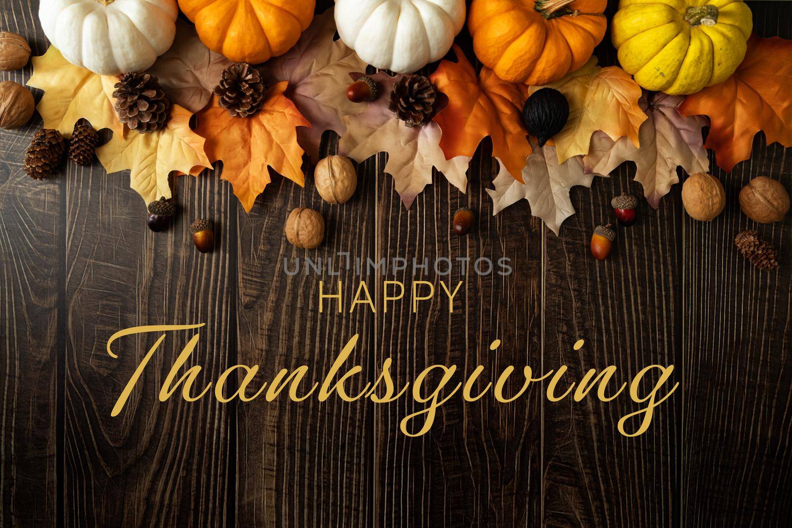 Happy Thanksgiving Day with pumpkin and nut on wooden table