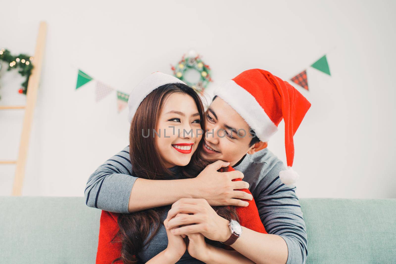 Christmas Asian Couple.Happy Smiling Family at home celebrating. New Year People