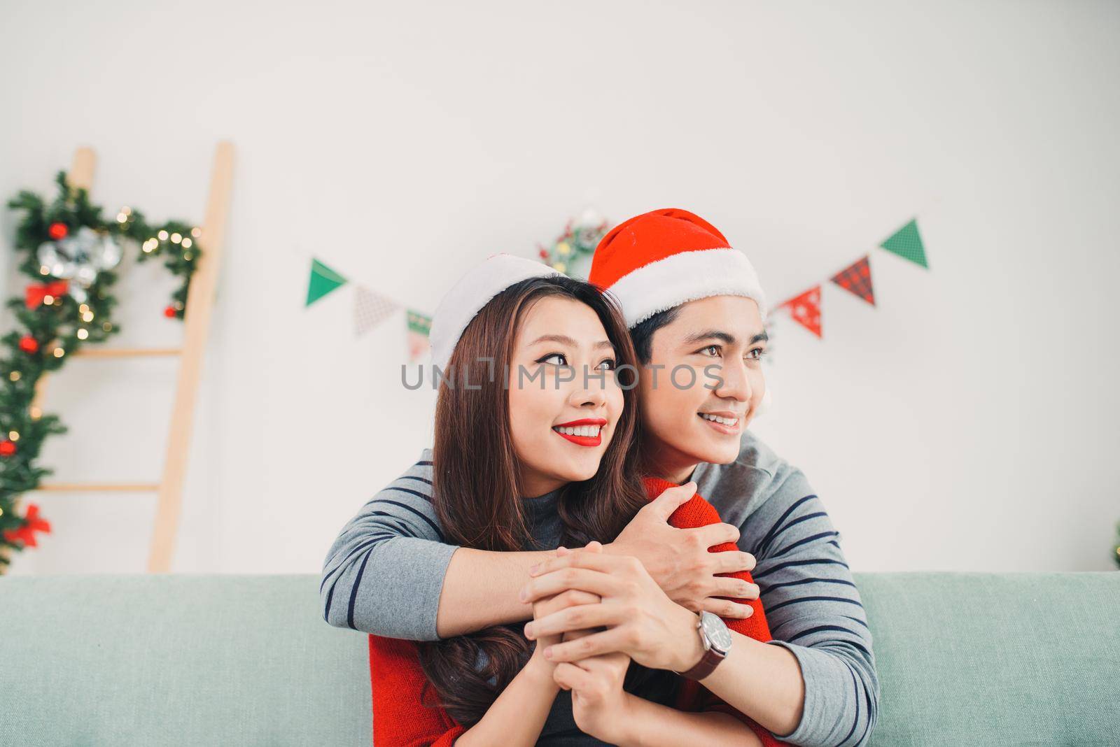 Christmas Asian Couple.Happy Smiling Family at home celebrating. New Year People