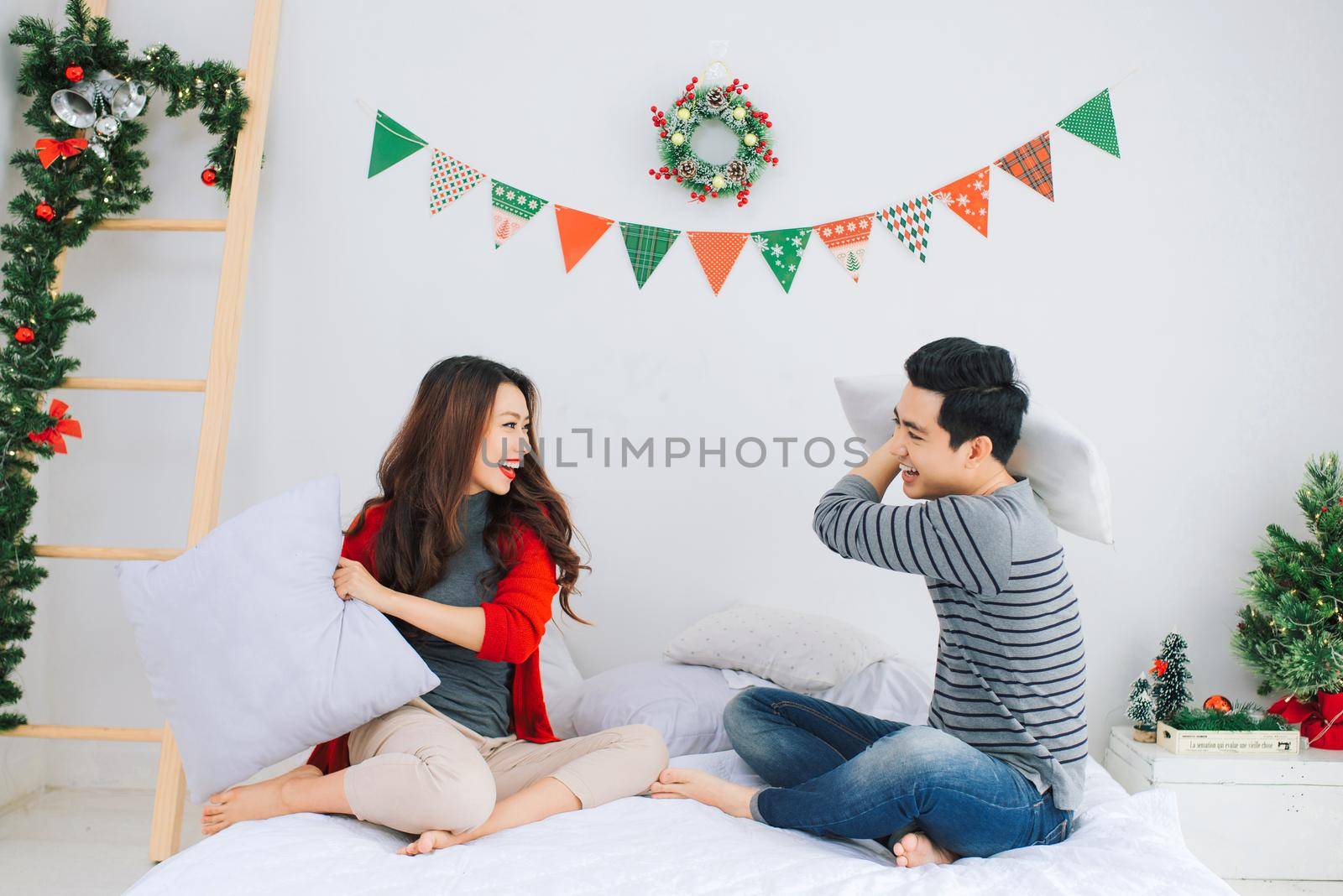 Christmas. Asian Couple at home celebrating New Year. by makidotvn