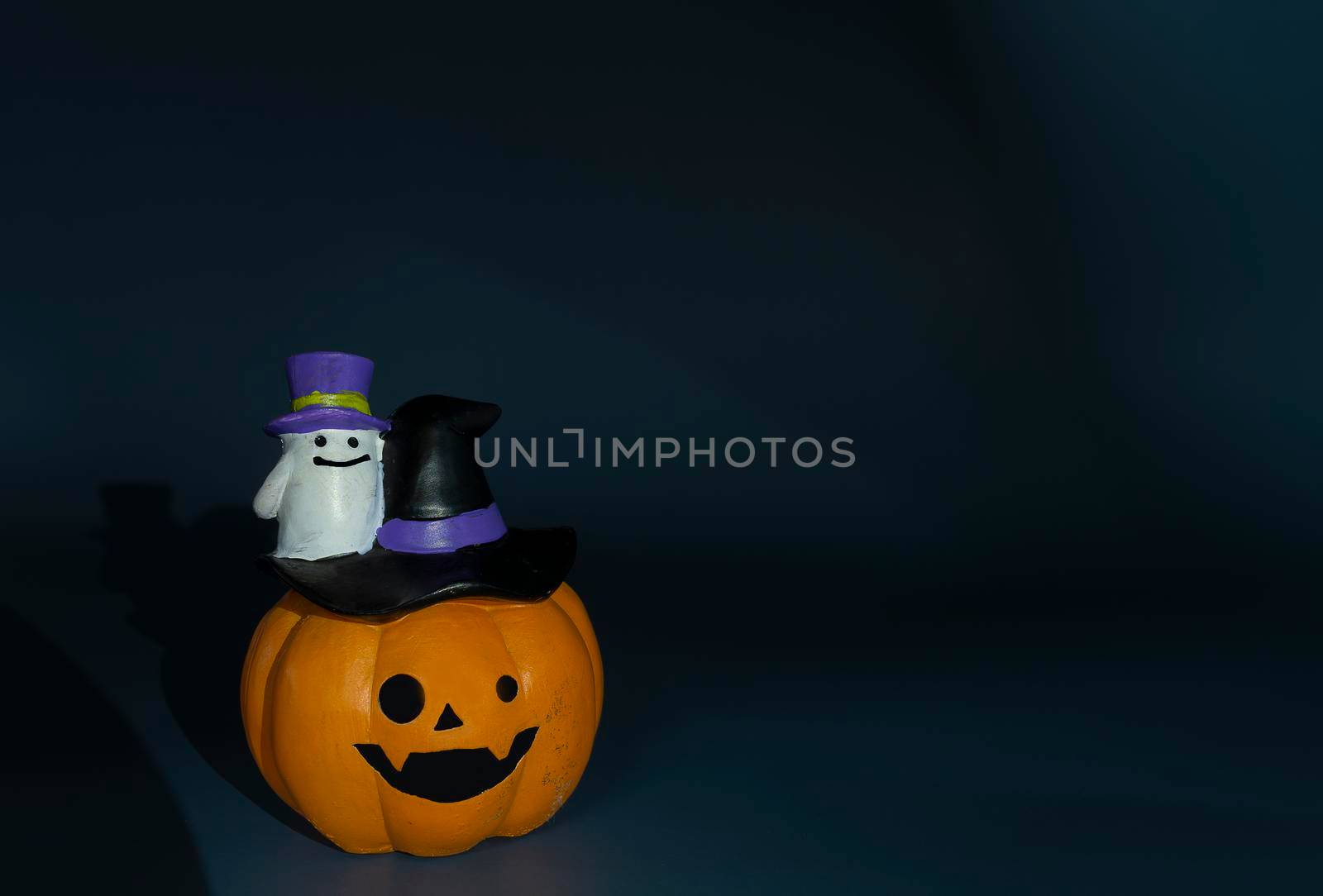 Halloween glitter pumpkin jack o lantern on a dark blue background. Halloween concept backdrop