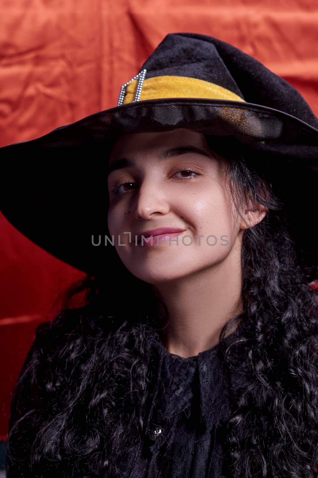 Portrait of a cute multi-racial woman in witch cap by golibtolibov