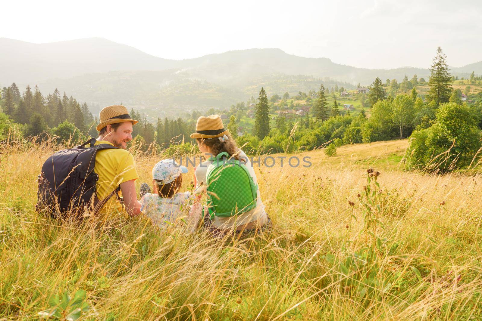 Active summer holiday lifestyle travel mountain family vacation. Children hiking mountain vacation travel family holiday kids and parents happy time together. Mountain trip family picnic. Green travel