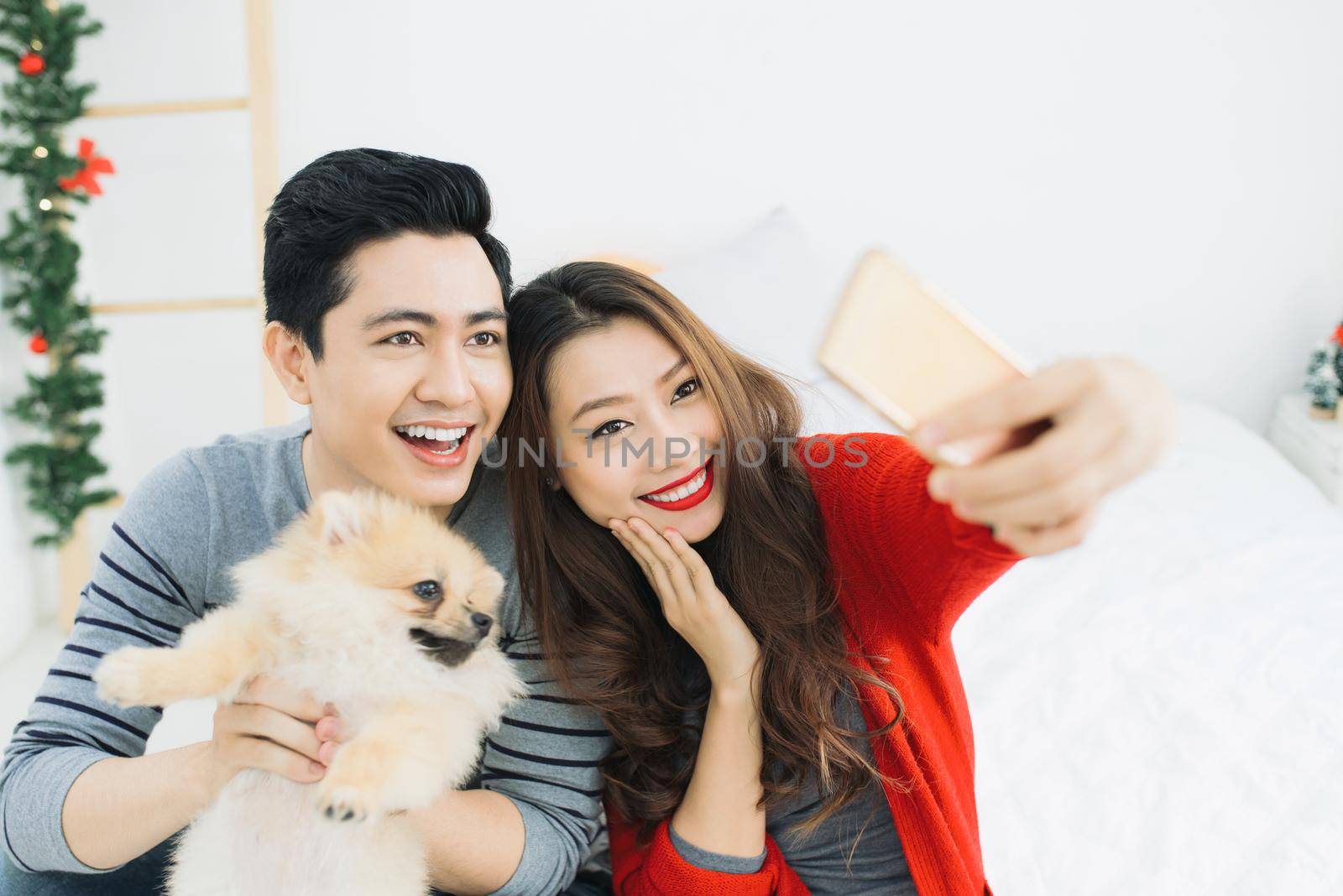 Christmas Asian Couple.Happy Smiling Family at home celebrating.New Year People