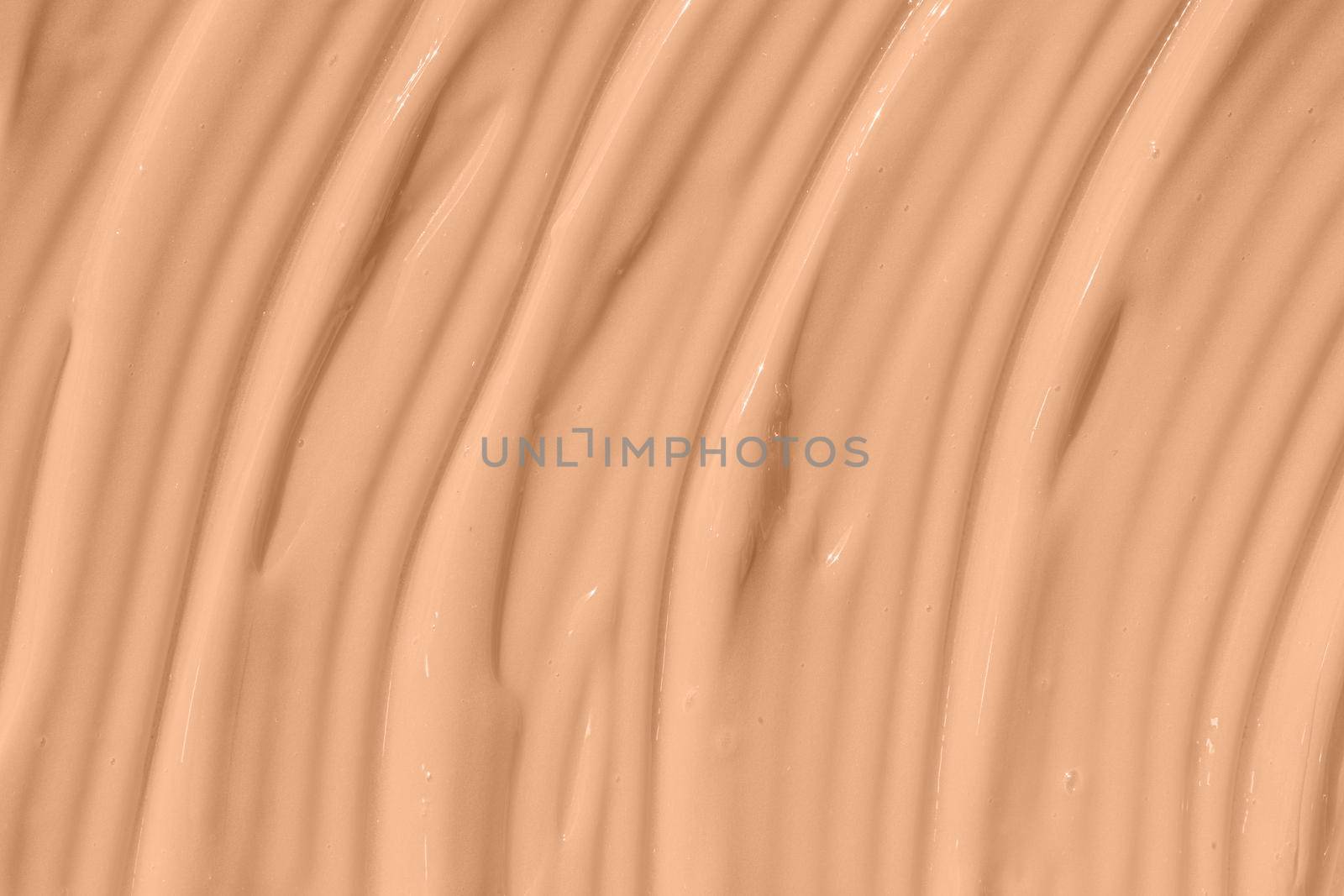 Beige nude liquid foundation texture, concealer smear smudge drop. Make up base, cream textured background. Closeup macro. Cosmetic tonal makeup moisturizer, bb cream swatch sample.