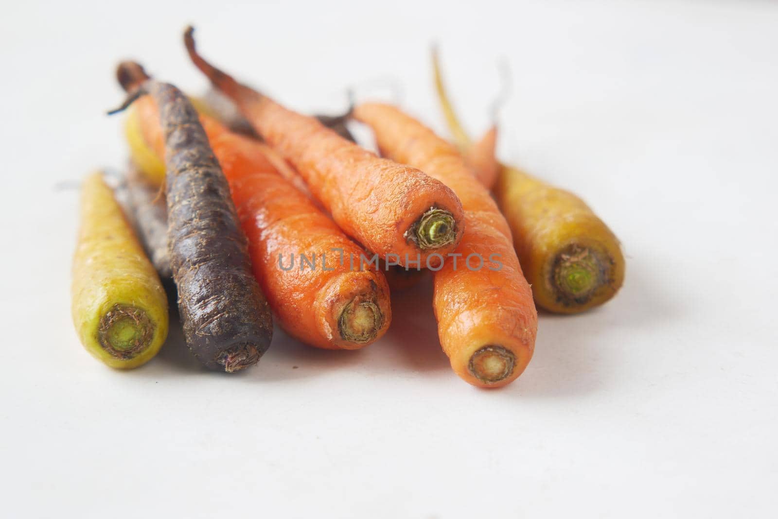 mixed colorful carrot on white background .